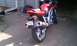 2003 Suzuki SV1000S - A red motorcycle is parked in a driveway, with its rear end facing the camera.