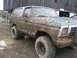 1979 Ford Bronco - This heavily mud-caked 1978 Ford Bronco is parked in front of a wooden barn.