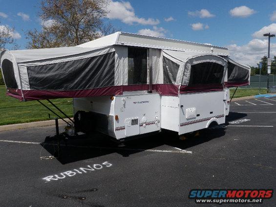 Fleetwood Arcadia pop-up camper parked on asphalt with 'RUBINOS' written on the ground