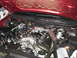2004 Mercury Grand Marquis - The engine bay of a vehicle is shown with the hood open, revealing the engine and various parts.