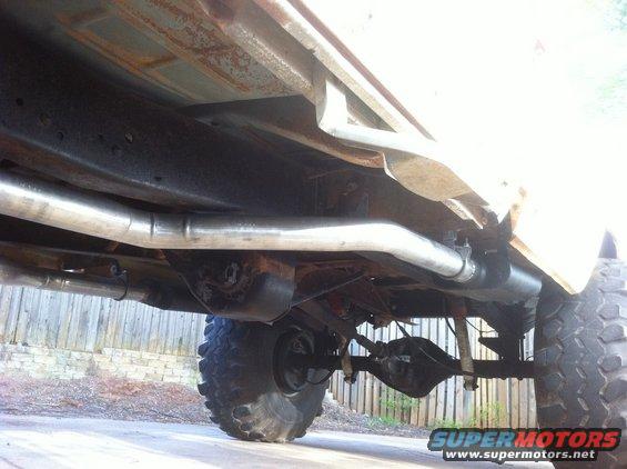 Underside view of a pickup truck's rear axle and exhaust system