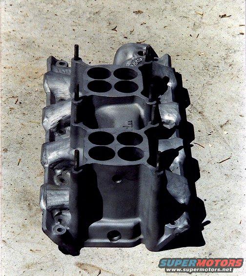 Aluminum intake manifold with four large circular openings on top