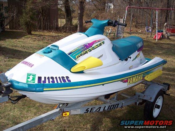 White and teal Yamaha WaveRunner jet ski on a trailer. Has 'Waveraider' graphics