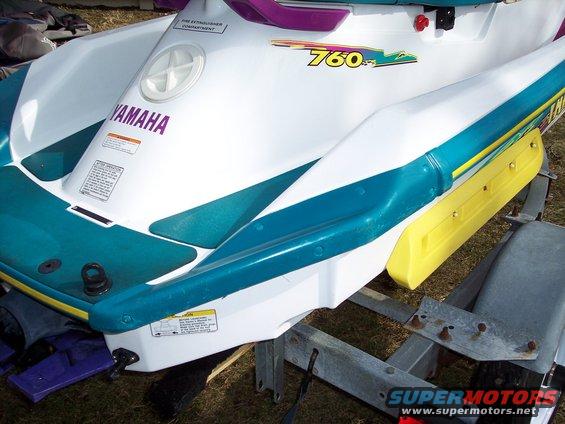 White jet ski with teal trim and yellow bumper, showing '760' badge