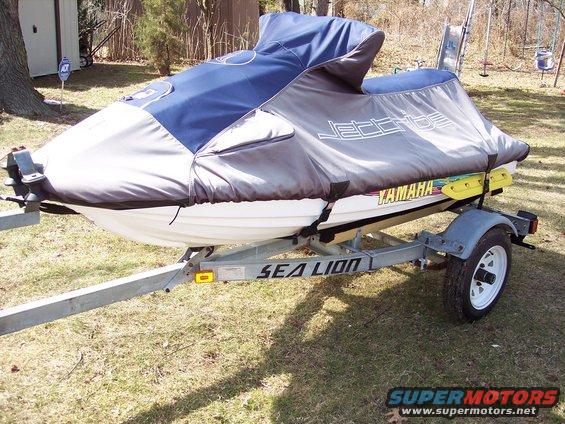 Jet ski on a trailer, covered in a blue and gray tarp. Yamaha logo visible