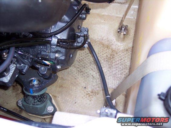 Jet ski engine and hoses in compartment. SuperMotors.net logo visible