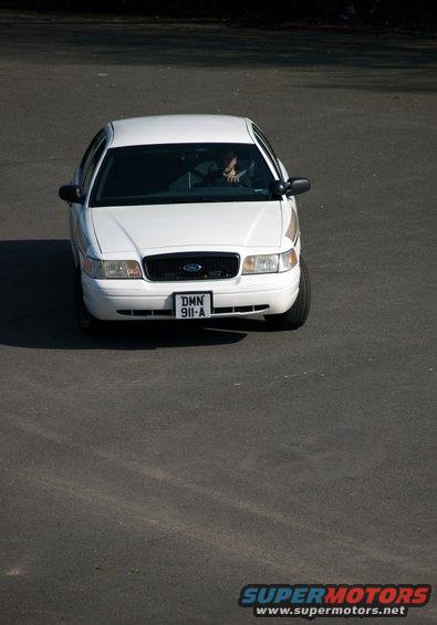 White 2001 Ford Crown Victoria driving on pavement