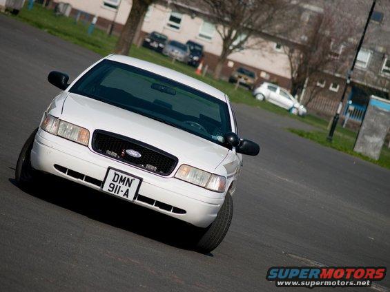 White 2001 Ford Crown Victoria front 3/4 view with license plate DMN 911-A