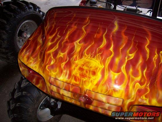 Truck front with flame and skull airbrushing, large tires