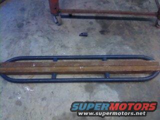 Rock sliders with wooden inserts, Supermotors.net logo visible