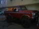 1978 Ford Bronco - This lifted 1978 Ford Bronco is parked in front of a building.