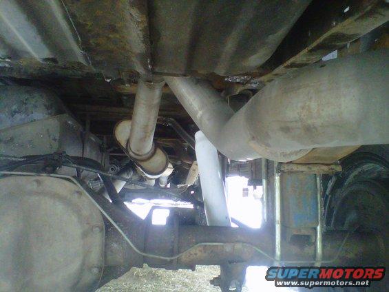 Underside view of a 1994 Ford F-150 showing the rear axle, exhaust system, and fuel tank