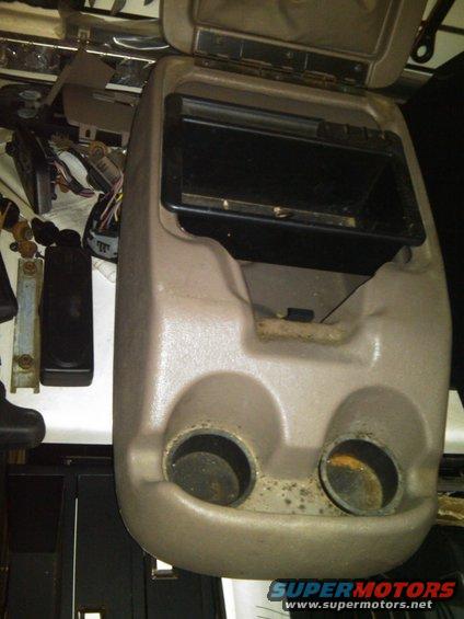 Center console part with two cup holders and open storage compartment