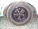 1966 Oldsmobile Cutlass - A close-up shows a car's wheel and tire, with the car body visible above.