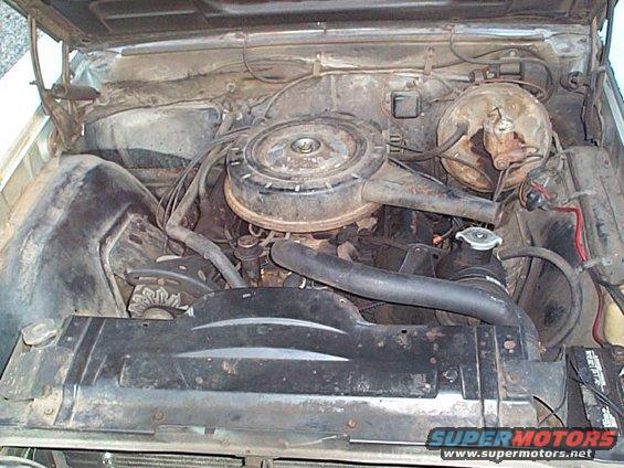 Engine bay view showing air cleaner, radiator, and battery