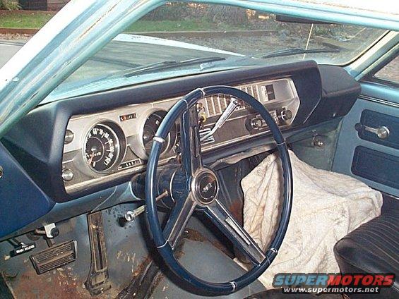 1966 Oldsmobile Cutlass interior with blue dashboard and steering wheel
