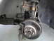 2003 Ford Taurus - The front wheel assembly of a vehicle, showing the brake system and suspension, is pictured here.