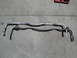 2003 Ford Taurus - Two automotive sway bars are shown side-by-side on a concrete surface.