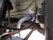 2003 Ford Taurus - Close-up of a vehicle's undercarriage, focusing on suspension parts like the sway bar and bushings.