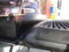 2003 Ford Taurus - The edge of a car's trunk lid shows wear and tear, with a ribbed surface visible.