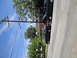 2003 Ford Taurus - A 2003 Ford Taurus is parked on the street alongside another dark sedan.