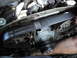 2003 Ford Taurus - Close-up view of a car's engine timing belt and water pump assembly.