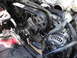 2003 Ford Taurus - Close-up view of the engine's timing belt, pulleys, water pump, and alternator.
