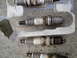 2003 Ford Taurus - A set of four spark plugs, with part numbers visible on some, are packaged in a clear plastic holder.