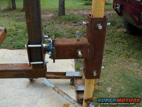 Rusted metal frame with bolts and bearing, Supermotors.net logo