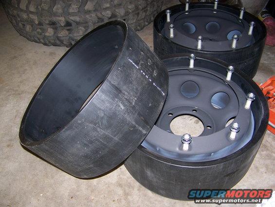 Two tire inserts and three wheels with lug nuts