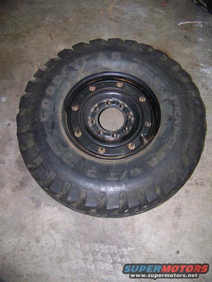 Black Goodyear Wrangler tire on a black metal wheel with visible lug nuts