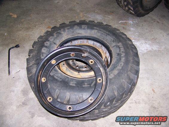 Tire and wheel assembly with a lug wrench on a concrete floor
