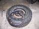 2001 Dodge 1500 - A tire and wheel assembly is shown with a lug wrench nearby on a concrete surface.