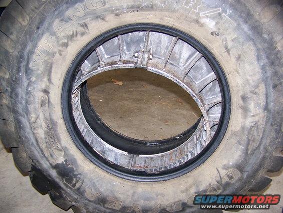 Tire with a metal double beadlock assembly inside, showing the inner rim and tire wall