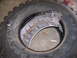 2001 Dodge 1500 - A damaged tire with a bent rim visible inside. The tire has 'WRANGLER' text on its sidewall.