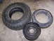 2001 Dodge 1500 - A Goodyear tire, a steel wheel, and a metal beadlock ring are laid out on a garage floor.
