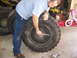 2001 Dodge 1500 - A person is shown working on a large tire, possibly changing it or performing maintenance.