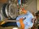 2001 Dodge 1500 - A person in protective gear works on a large wheel rim, possibly for a truck or heavy equipment.