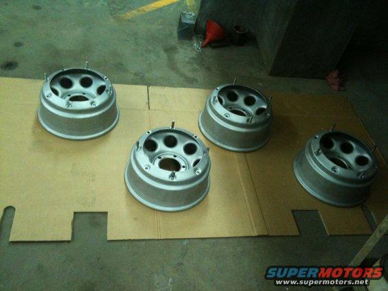 Four silver beadlock wheels on cardboard