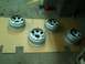 2001 Dodge 1500 - Four silver beadlock wheels are laid out on cardboard, possibly awaiting installation or preparation.