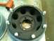 2001 Dodge 1500 - A black steel wheel, likely for a truck or SUV, is shown with lug nuts installed and a rubber mallet in the background.