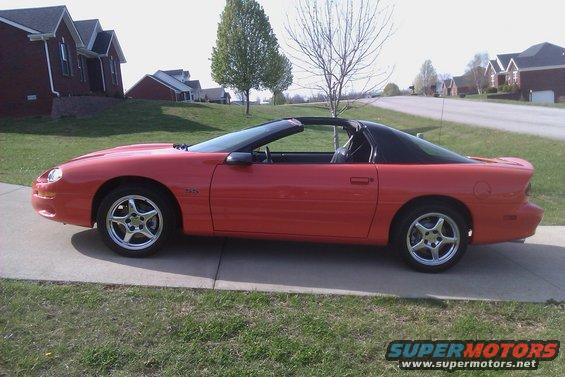 1999 Chevrolet Camaro convertible, side view. Red paint, black t-top roof