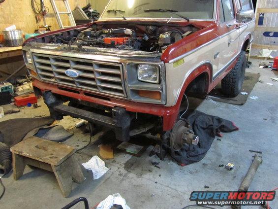1980 Ford Bronco front end, hood open, undergoing repairs