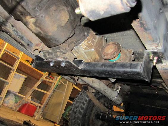 Underside of a vehicle showing a transfer case, differential, and suspension components