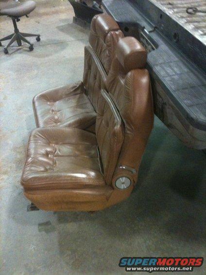 Brown leather bucket seats with chrome accents, likely from a truck
