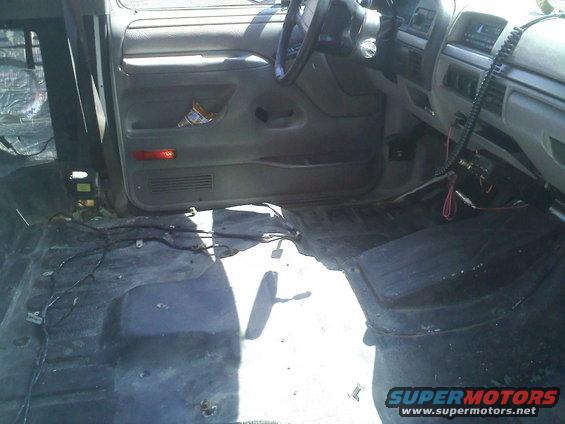 1994 Ford Bronco interior with removed flooring and exposed wiring