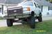 1989 Ford Bronco - This lifted Ford Bronco has a prominent aftermarket grille guard and appears to be from the late 1980s.