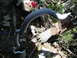 2003 Ford Taurus - A gray sway bar is pictured in a cluttered outdoor area with various discarded items.
