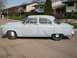 1952 Ford Mainline - This 1952 Ford Mainline sedan is shown from the side. The "Mainline" script is visible on the front fender.