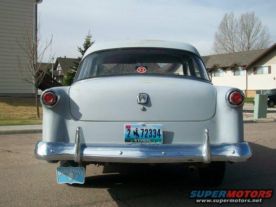 Rear view of a light blue 1953 Ford sedan with a Wyoming license plate